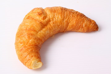 Fresh and tasty croissant over white background
