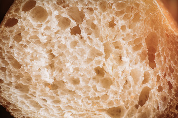 Freshly baked baguette bread on the rustic background. Selective focus. Shallow depth of field.