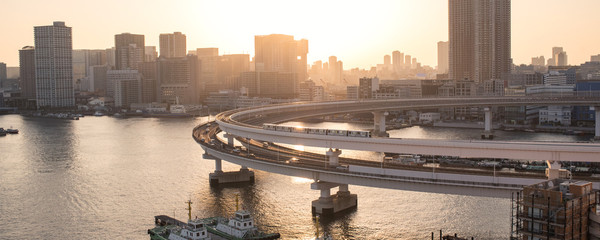 Yurikamome Train on Rainbow Bridge and Tokyo skyline at...