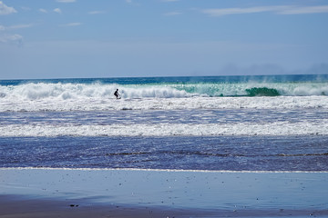 Fototapeta na wymiar Beautiful aerial view of surfers surfing in Naranjo Beach 
