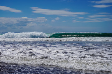 Beautiful aerial view of surfers surfing in Naranjo Beach 