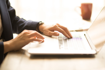 Woman working at home office hand on keyboard close up 