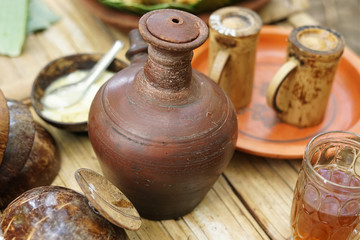Traditional earthenware jug with some kitchen appliances around