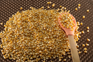 Popcorn corn grains on a kitchen table and household items