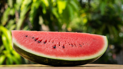 Watermelon slice on green background