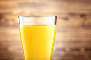 Orange juice  in glass on wooden background.
