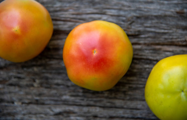 Unripe tomatoes on a rustic wooden background