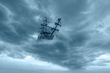 Fototapeta na wymiar Flying old ship in the clouds