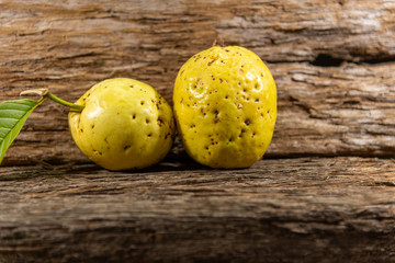 Yellow guava fruits isolated on aged wooden background