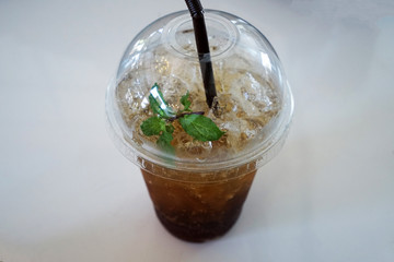 Close up plastic take away cup of iced black tea