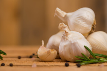 Garlic and spices on a wooden background, cooking saver