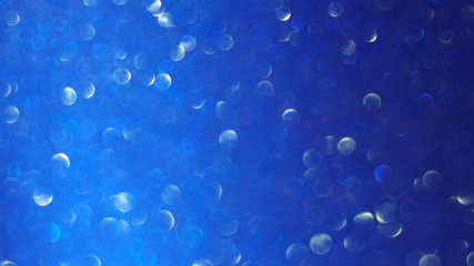 Blurred abstract photo of light burst and glitter golden bokeh lights.  