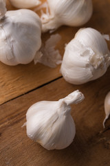 A lot of garlic on a wooden background, spices