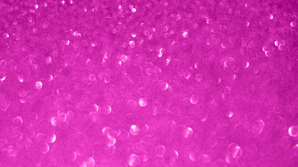 Blurred abstract photo of light burst and glitter golden bokeh lights.  