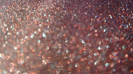 Blurred abstract photo of light burst and glitter golden bokeh lights.  