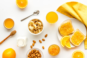 Granola for healthy breakfast. Still life composition with fruits and toast on white background top-down