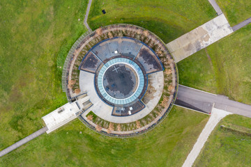 Aerial view of a modern building beside a French town, Museo Parc Alesia