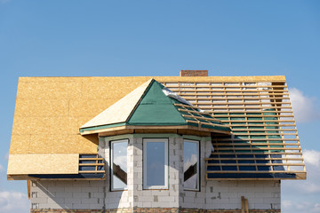 New house under construction with unfinished roof