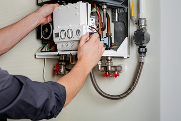 Repair of a gas boiler. - obrazy, fototapety, plakaty