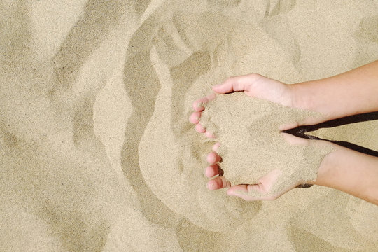 Sand In Hands Of Girl. Hand Strew Sand