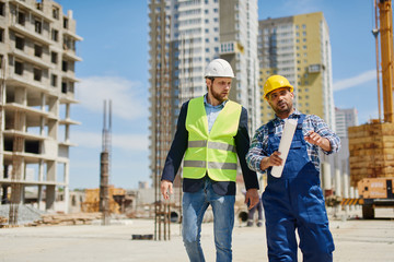 Two engineers discuss work related questions together.