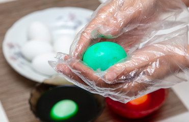 Painting eggs in the kitchen.