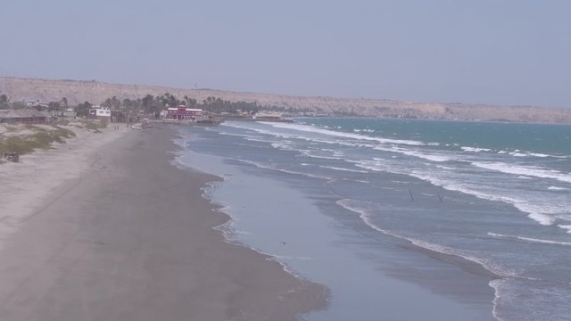 Pullback and right traveling view move of waves on Colan Beach in Piura Region, Peru