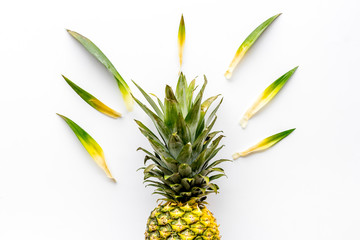 Pineapple on white background with leaves top-down