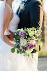 wedding bouquet in hands of bride and groom - 328228248