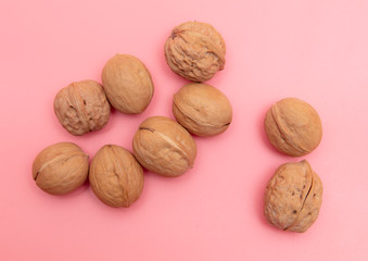 Walnuts on a pink background.