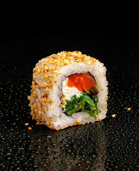 Traditional Japanese sushi on a black glossy background