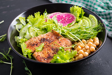 Trendy salad. Buddha bowl dish with chicken fillet, chickpea, cucumber, radish,  fresh lettuce salad, pea sprouts  and chia seeds. Healthy food.
