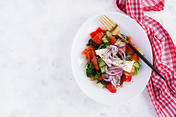 Trendy salad. Greek salad  with fresh vegetables, feta cheese and black olives.  Healthy balanced eating. Top view, overhead, flat lay