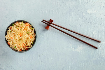 Instant noodles bowl with carrot and scallions, a vegetable soba bowl, overhead shot with...