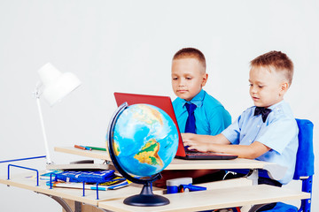 boys schoolchildren in class at a desk in the classroom at school