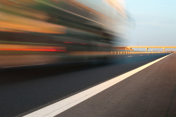 Fototapeta na wymiar Bus traveling on highway. Motion blur effect