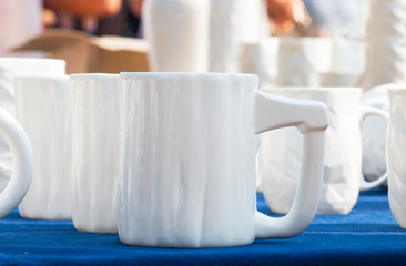 beautiful white mug on a blue table, street trading
