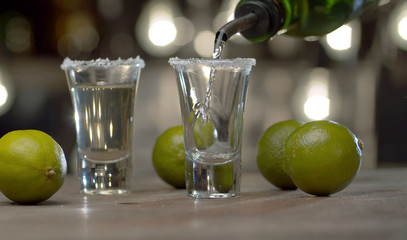 Bartender pouring tequila into glasses