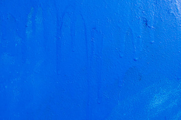 Wall with old paint. Smudges with drops. Main color Navy Blue.