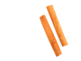 Two sticks of spice cinnamon on white isolated background. Indian cuisine, ayurveda, naturopathy concept