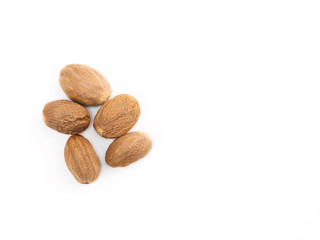 Five nutmegs on white isolated background. Indian cuisine, ayurveda, naturopathy concept