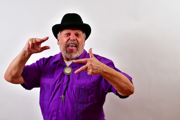 Fototapeta premium Older gentleman making a crazy face and hand gestures.