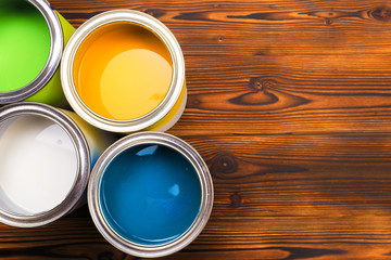 House renovation, paint cans on the old wooden background with copy space - Image