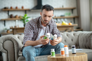 Young man in a checkered shirt reading instructions