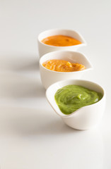 Famous Canary Islands mojo or sauces Mojo picon, Mojo verde and Almogrote in white elegant bowl on the restaurant table.