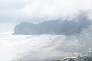 Aerial view of North Piha beach covered in thick fog