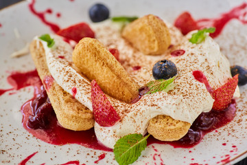 Gentle soft tiramisu. Cookies with mascarpone cream and fresh fruit.
