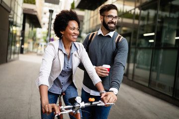 View at young business people talking and smiling outdoors