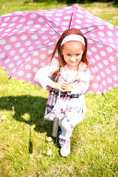 Little girl with polka dots umbrella