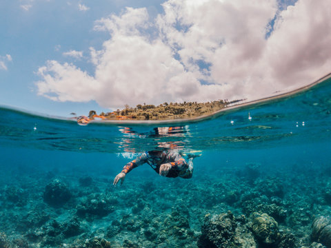 Man snorkeling in the sea, Lipah beach, Amed, Bali.